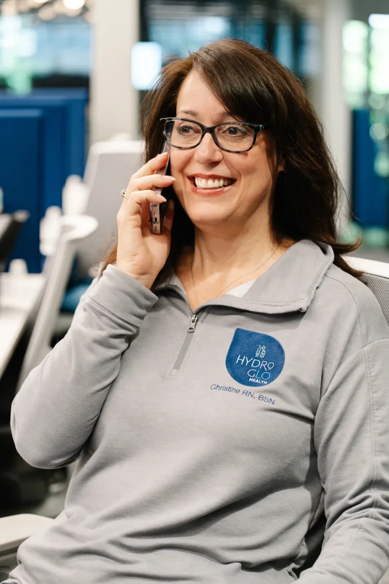 Christine DiNoia, BSN, RN, on a phone call in her office